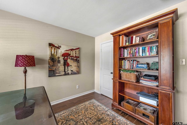 home office with dark wood-type flooring