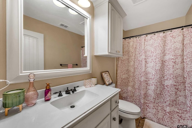 bathroom featuring tile patterned flooring, vanity, and toilet