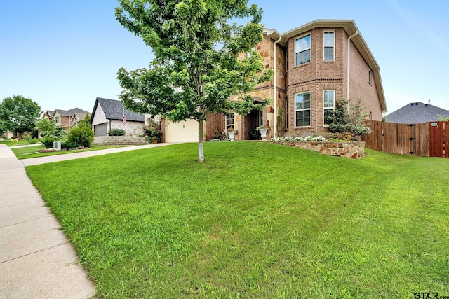 view of front of house featuring a front lawn and a garage