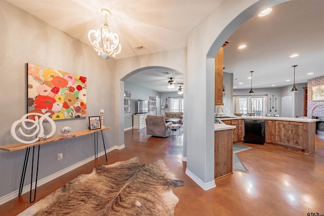 interior space with concrete flooring, a chandelier, and sink