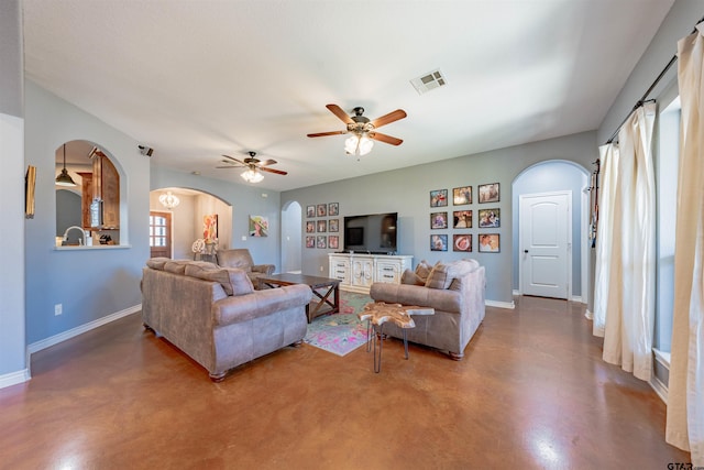 living room featuring concrete floors and ceiling fan