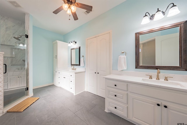 bathroom with vanity, an enclosed shower, and ceiling fan