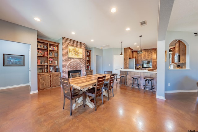 dining area with a fireplace and built in features