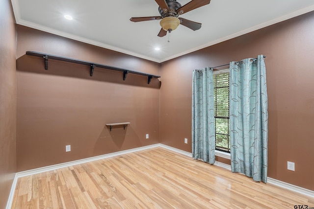 unfurnished room with baseboards, wood finished floors, a ceiling fan, and ornamental molding