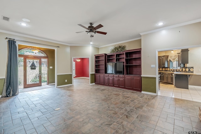 unfurnished living room with ornamental molding, ceiling fan, and sink