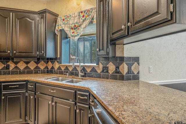 kitchen with backsplash, sink, and dark brown cabinetry