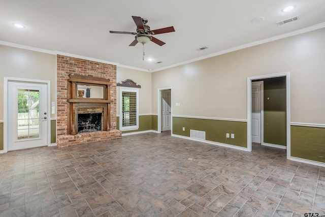 unfurnished living room featuring a fireplace, ceiling fan, and crown molding