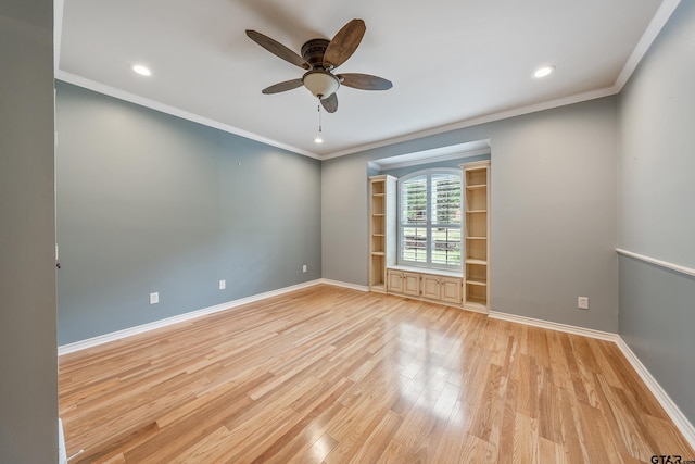 empty room featuring ornamental molding, light hardwood / wood-style floors, and ceiling fan