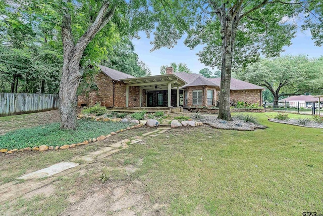 ranch-style home with a front yard and a patio area