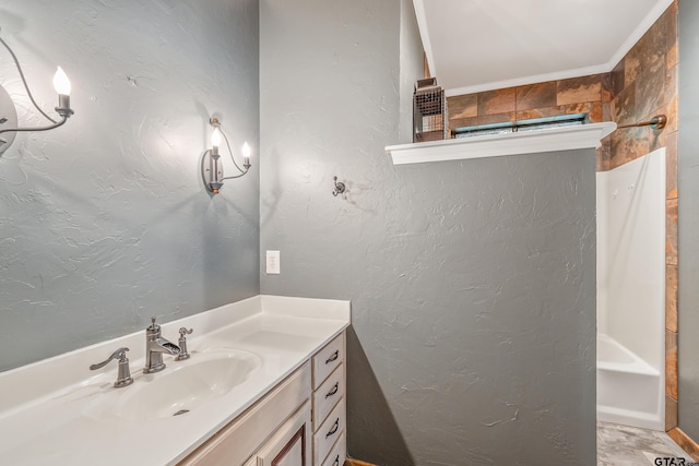 bathroom featuring vanity and a textured wall