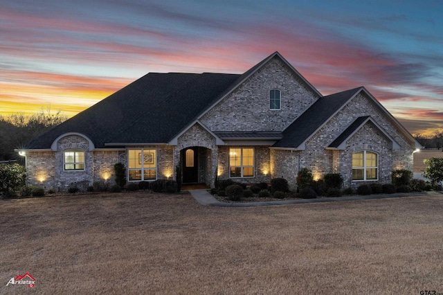 french provincial home with a yard