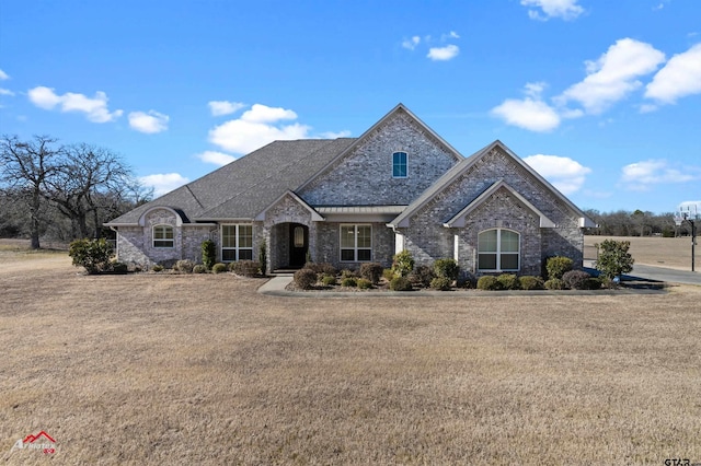 french country home with a front lawn