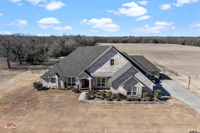 french country inspired facade with a front yard