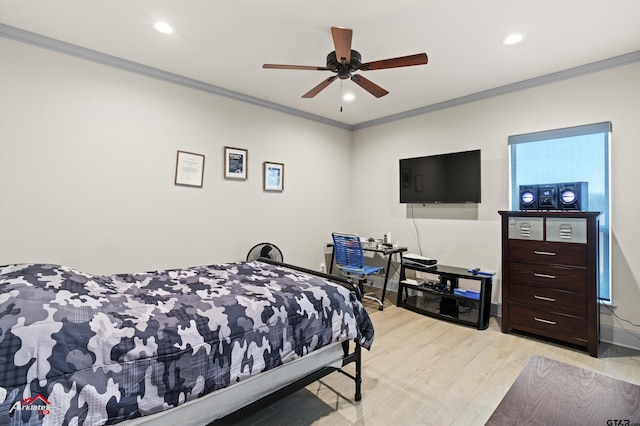 bedroom featuring ceiling fan, ornamental molding, and light hardwood / wood-style flooring