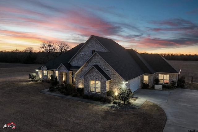 french country home featuring a garage