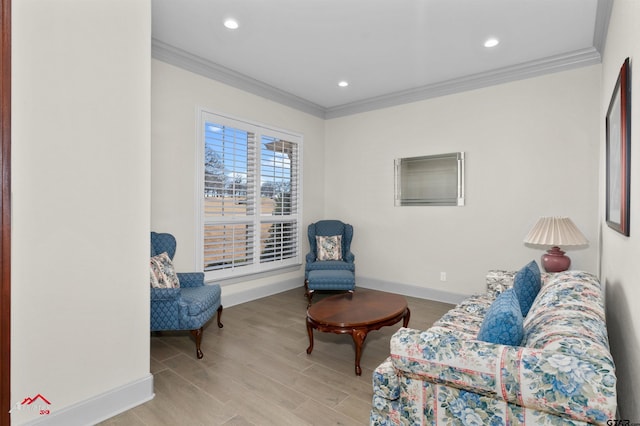 living area with crown molding and light hardwood / wood-style flooring