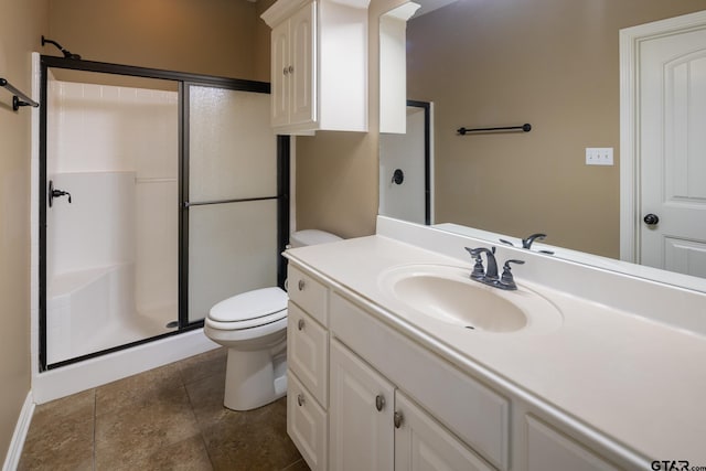 bathroom with a stall shower, vanity, and toilet