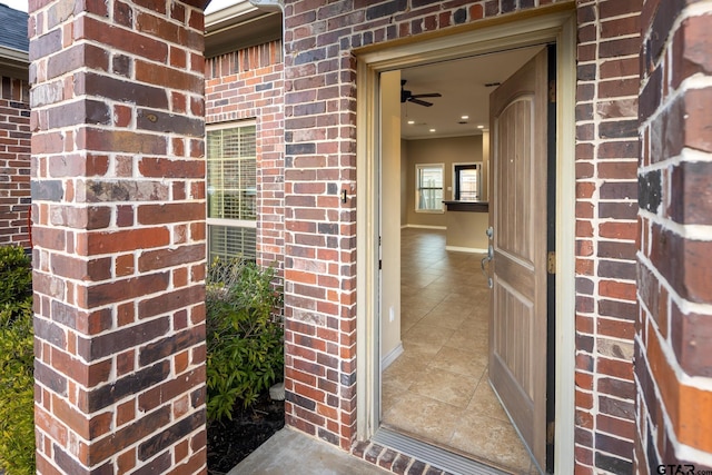 doorway to property with brick siding