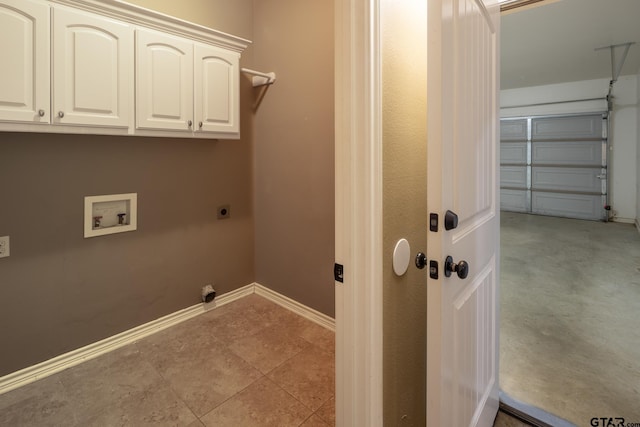 laundry room with washer hookup, cabinet space, hookup for an electric dryer, a garage, and baseboards