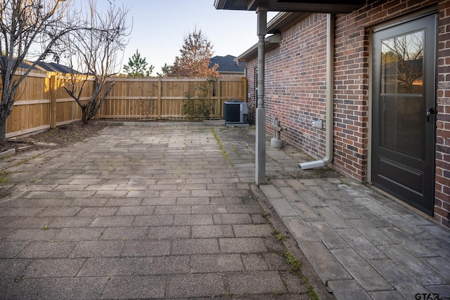 view of patio / terrace with a fenced backyard and central air condition unit