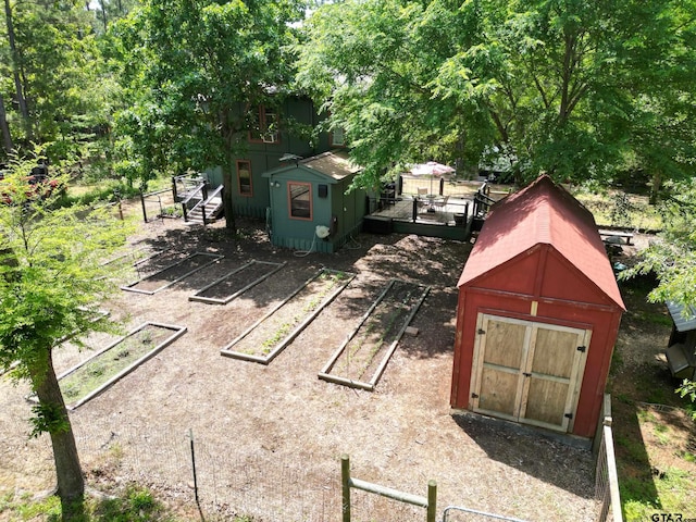 exterior space with a deck, a storage unit, and an outdoor structure