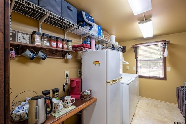 clothes washing area featuring tile patterned floors, washer / dryer, and laundry area