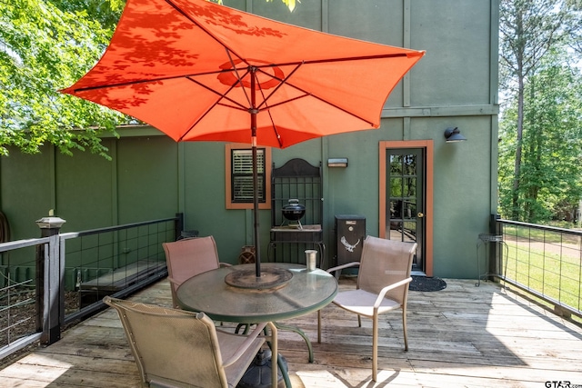 wooden deck featuring outdoor dining area