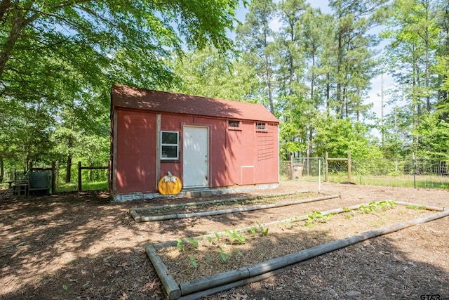 view of shed featuring fence
