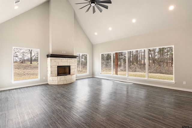 unfurnished living room featuring ceiling fan, dark hardwood / wood-style flooring, high vaulted ceiling, and a fireplace