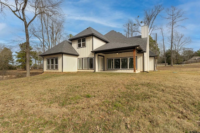 rear view of property with a yard