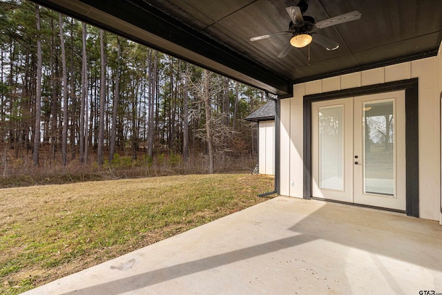 property entrance with a patio area, ceiling fan, french doors, and a lawn