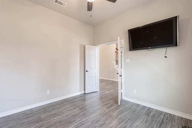 unfurnished room with ceiling fan and hardwood / wood-style flooring