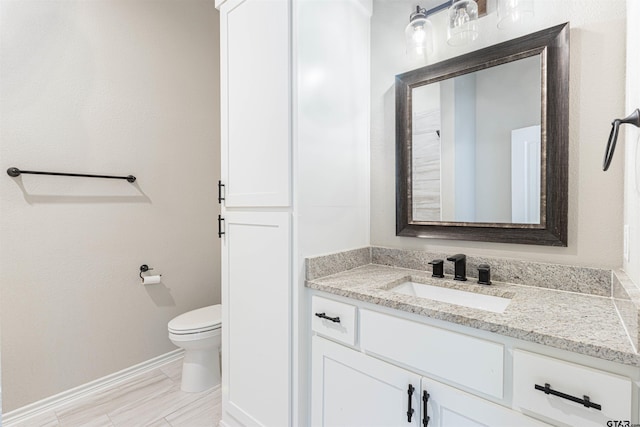 bathroom featuring toilet and vanity