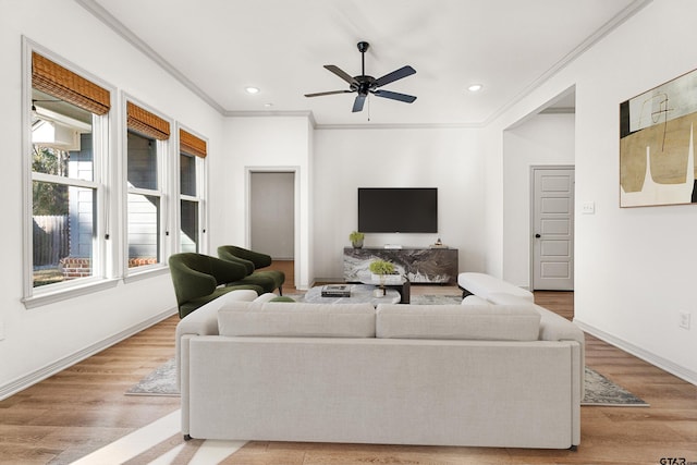 living room featuring crown molding, light hardwood / wood-style floors, and ceiling fan