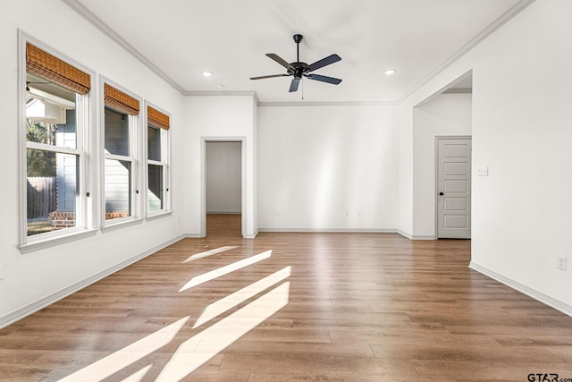 unfurnished room featuring crown molding, ceiling fan, and light hardwood / wood-style flooring