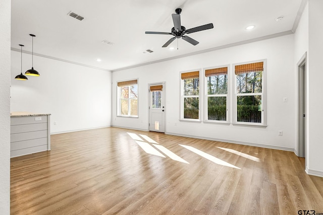 unfurnished living room with crown molding, ceiling fan, and light hardwood / wood-style floors