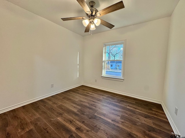 unfurnished room with ceiling fan, baseboards, and dark wood finished floors