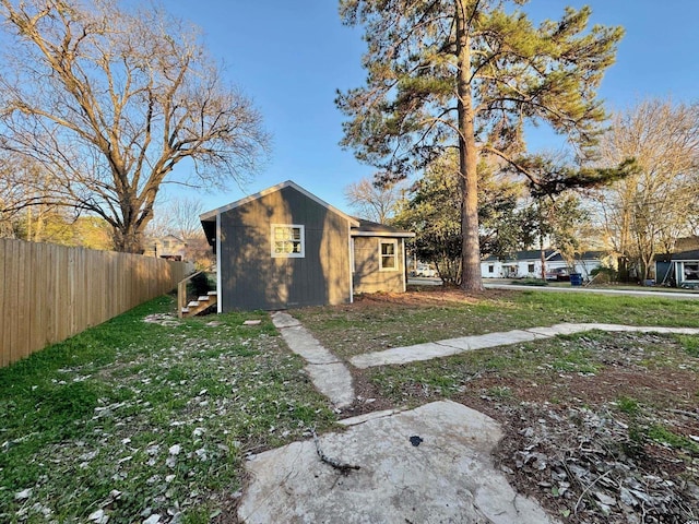 view of side of property featuring a yard and fence