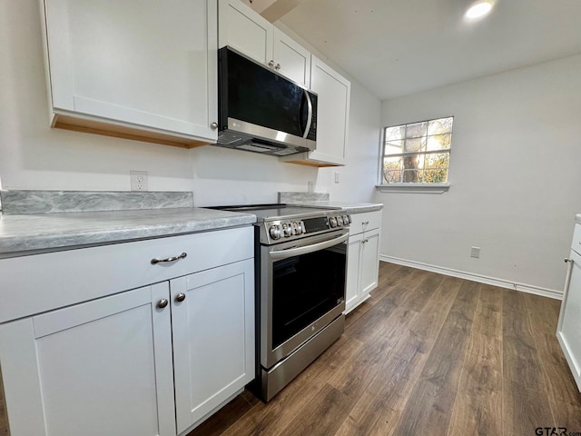 kitchen with stainless steel range with electric stovetop, white cabinetry, light countertops, and dark wood-style flooring