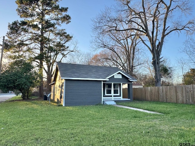 view of outbuilding with fence