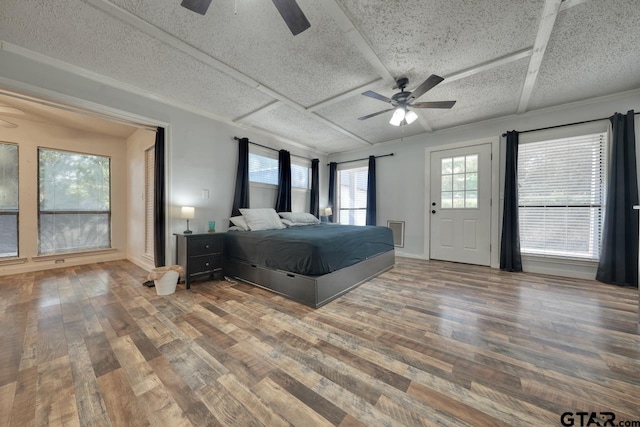 unfurnished bedroom featuring hardwood / wood-style flooring, a textured ceiling, and ceiling fan