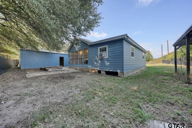 back of house featuring a sunroom, a lawn, and cooling unit