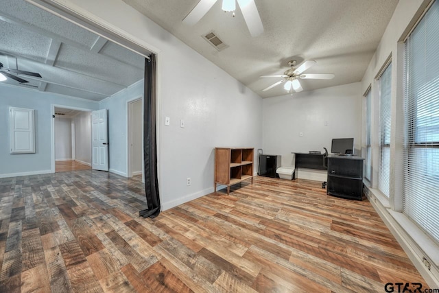 unfurnished office featuring ceiling fan, wood-type flooring, and a textured ceiling