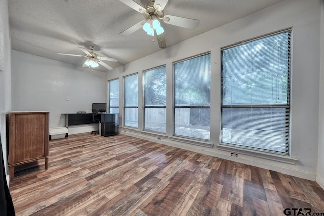 unfurnished office featuring hardwood / wood-style flooring, a textured ceiling, and ceiling fan