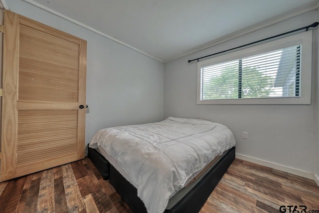 bedroom featuring ornamental molding and dark hardwood / wood-style floors