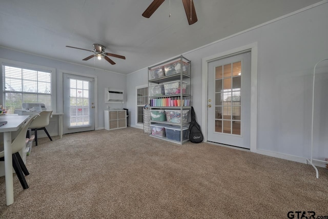 misc room with an AC wall unit, carpet flooring, ceiling fan, and crown molding