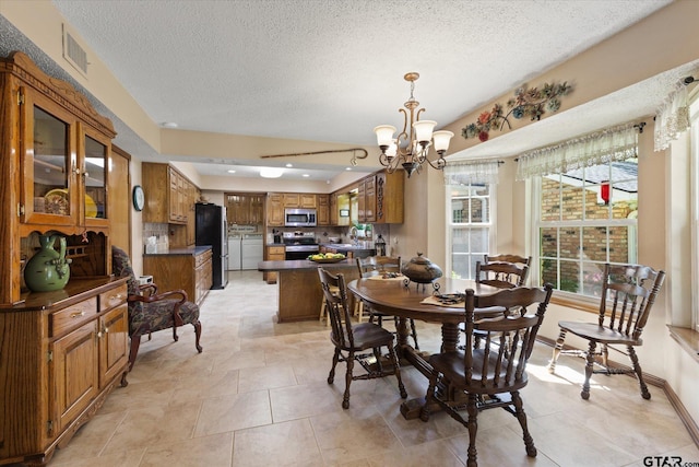 408 E Forest Dr, White Oak, TX 75693 - dining space with a chandelier, a textured ceiling, and baseboards