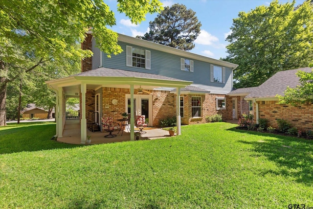 408 E Forest Dr, White Oak, TX 75693 - back of property with a chimney, a lawn, a ceiling fan, brick siding, and a patio area
