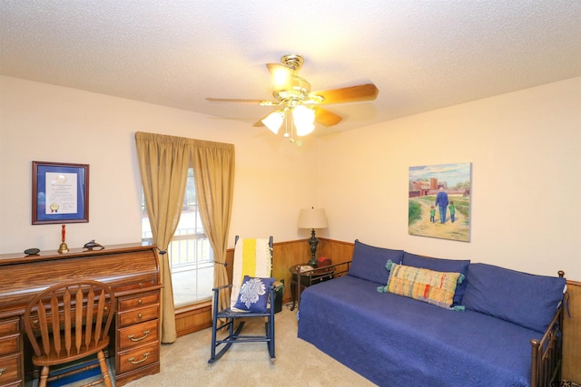 bedroom with light carpet, ceiling fan, and a textured ceiling