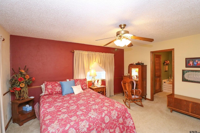 carpeted bedroom featuring ceiling fan and a textured ceiling